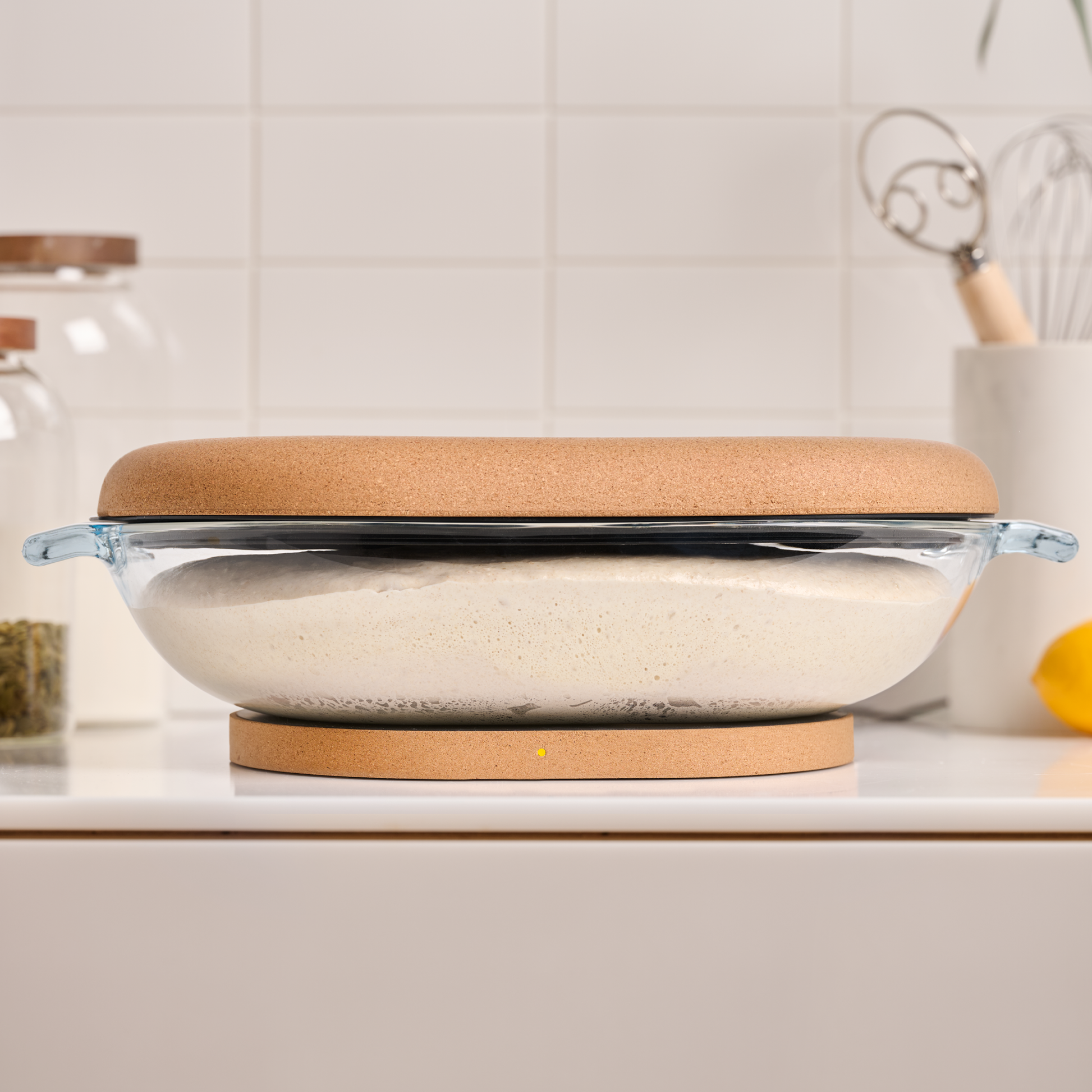 DoughBed glass bowl for bread dough proofing in use with sourdough dough on kitchen counter