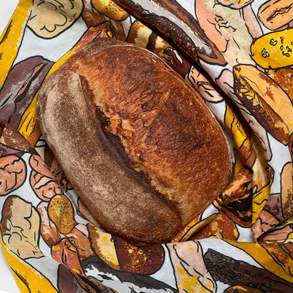 Loaf of bread on a Sourhouse Bread Blanket: patterned cotton cloth with bread design